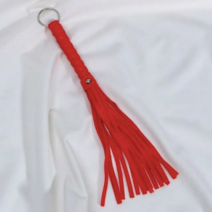 Whip with decorated handle and ring, red